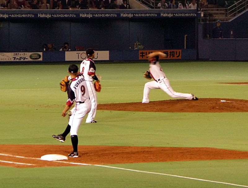 Naruse throws a loaf of French bread in warmups