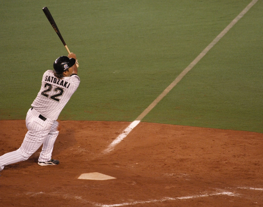 Sato blasts a deep fly off the right field fence