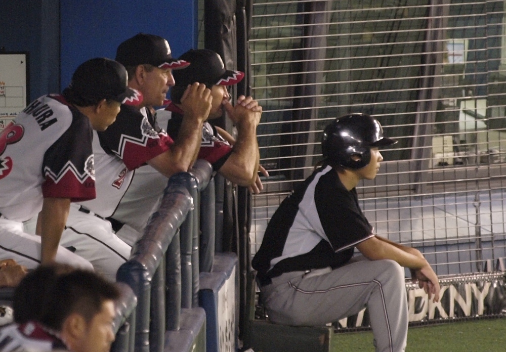 Dugout Bobby, Frank, and Nishimura watch Watanabe in anticipation