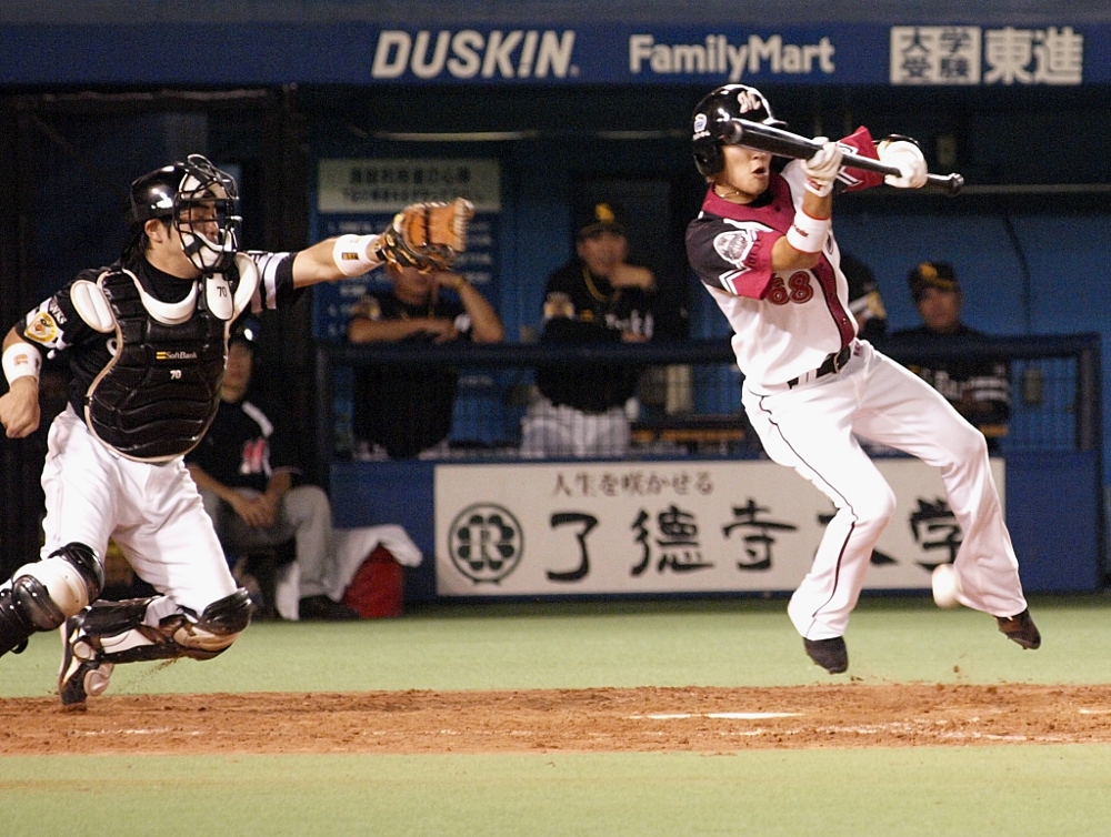 Squeeze1 Hayasaka leaps to get his bat on the ball